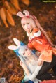 A couple of women dressed in bunny ears pose for a picture.